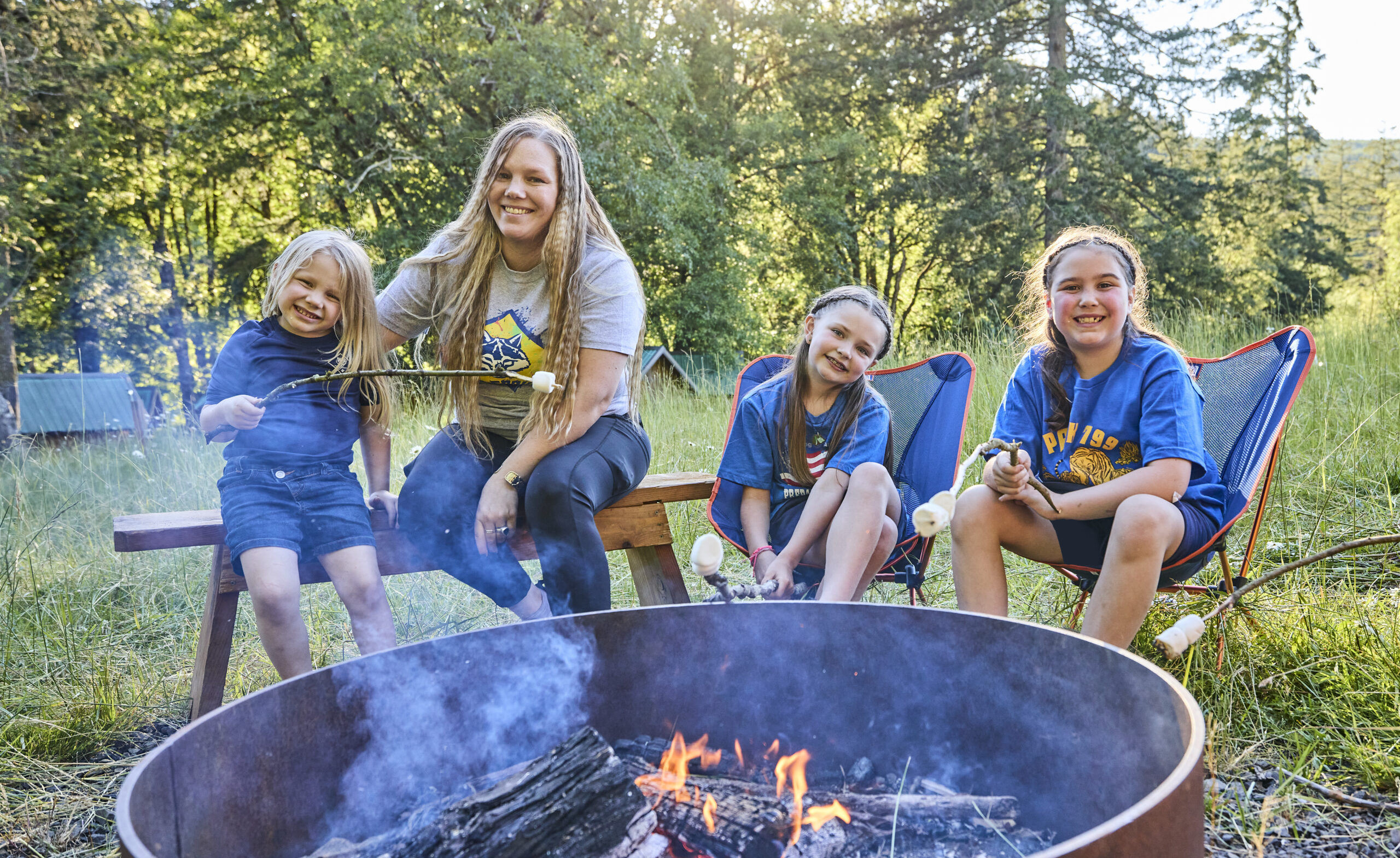 Cub Scouts sitting around a campfire making and eating s'mores